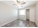 This bedroom features a ceiling fan, a window for natural light and a sliding closet door at 7559 W Turquoise Ave, Peoria, AZ 85345