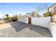 View of the home's garage with a wooden entry gate and concrete driveway at 7559 W Turquoise Ave, Peoria, AZ 85345