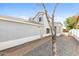 View of home's side and entry with gravel landscaping at 7559 W Turquoise Ave, Peoria, AZ 85345