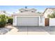 Attached two-car garage with a driveway for additional parking at 7559 W Turquoise Ave, Peoria, AZ 85345