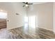 Living room boasting wood-look floors, vaulted ceiling, and staircase at 7559 W Turquoise Ave, Peoria, AZ 85345