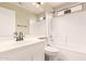 Bathroom with a single sink vanity, mirror, and a shower-tub combination with tiled walls at 7635 E Pampa Ave, Mesa, AZ 85212