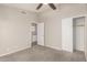 Bedroom featuring neutral carpet, closet, ceiling fan, and an adjoining bathroom at 7635 E Pampa Ave, Mesa, AZ 85212