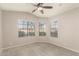 Bedroom featuring neutral carpet, ceiling fan, and windows offering a great source of natural light at 7635 E Pampa Ave, Mesa, AZ 85212