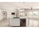 Spacious kitchen island with sink and dishwasher, connecting to dining and living areas at 7635 E Pampa Ave, Mesa, AZ 85212