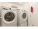 Laundry room with front load washer and dryer and a shelf with a basket at 7635 E Pampa Ave, Mesa, AZ 85212