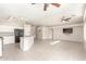 Open living space featuring tile floors, a kitchen island, and neutral walls at 7635 E Pampa Ave, Mesa, AZ 85212