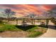 Community playground with picnic tables and sandy play area, set under a beautiful sky at 7635 E Pampa Ave, Mesa, AZ 85212