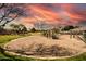 Community playground with sandy play area, surrounded by lush lawns and beautiful skies at 7635 E Pampa Ave, Mesa, AZ 85212