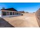 Spacious backyard featuring a screened-in porch and block wall fencing, offering privacy and outdoor living space at 8567 N 107Th Dr, Peoria, AZ 85345