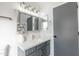 Updated bathroom features a stylish mirror, grey vanity, new fixtures, and a full view at 8567 N 107Th Dr, Peoria, AZ 85345