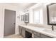 Bathroom with quartz counters, undermount sinks, and modern grey cabinets at 8567 N 107Th Dr, Peoria, AZ 85345