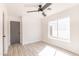 Bright bedroom features wood-look floors, a large window, and a ceiling fan at 8567 N 107Th Dr, Peoria, AZ 85345