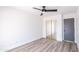 Neutral bedroom with wood-look floors, ceiling fan, and a full closet at 8567 N 107Th Dr, Peoria, AZ 85345