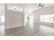 Living room with stylish flooring, modern ceiling fan, and bright natural light at 8567 N 107Th Dr, Peoria, AZ 85345