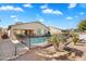 Backyard with a swimming pool, patio, desert landscaping and a black metal fence at 860 E Cierra Cir, San Tan Valley, AZ 85143