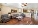 Open-concept living room with wood floors, ceiling fan, and views into the kitchen at 860 E Cierra Cir, San Tan Valley, AZ 85143