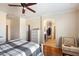 Cozy main bedroom featuring hardwood floors and an open ensuite bathroom at 860 E Cierra Cir, San Tan Valley, AZ 85143