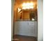 This bathroom features a vanity with white cabinets, a framed mirror and coordinated lighting at 8649 E Royal Palm Rd # 213, Scottsdale, AZ 85258