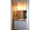 Well-lit bathroom features updated vanity with sink, mirror, and storage at 8649 E Royal Palm Rd # 213, Scottsdale, AZ 85258