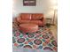 Cozy living room showcasing a brown couch and a colorful, patterned rug at 8649 E Royal Palm Rd # 213, Scottsdale, AZ 85258