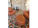 Comfortable seating area featuring an orange sofa, matching chair, and a colorful rug at 8649 E Royal Palm Rd # 213, Scottsdale, AZ 85258