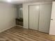 Bedroom with built-in closet storage, laminate flooring, and neutral walls for personalization at 9501 E Broadway Rd # 71, Mesa, AZ 85208