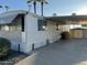 Manufactured home showing parking, storage shed, and low maintenance gravel yard with palm trees in the background at 9501 E Broadway Rd # 71, Mesa, AZ 85208