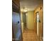 Hallway area with wood paneling, full sized stackable washer and dryer and access to another room at 9501 E Broadway Rd # 71, Mesa, AZ 85208