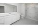 Modern bathroom featuring a spacious vanity with double sinks and a glass-enclosed shower at 9808 W Agora Ln, Tolleson, AZ 85353