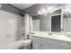 Bathroom featuring updated vanity, lighting, mirror and shower-over-tub at 1017 E Maryland Ave # 110, Phoenix, AZ 85014