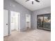 Bright bedroom featuring sliding glass doors, plush carpeting, ensuite and walk-in closet at 1017 E Maryland Ave # 110, Phoenix, AZ 85014