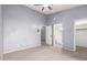 Spacious bedroom featuring neutral color palette, ceiling fan and multiple doors at 1017 E Maryland Ave # 110, Phoenix, AZ 85014