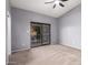 The primary bedroom has a ceiling fan and a sliding glass door to the backyard at 1017 E Maryland Ave # 110, Phoenix, AZ 85014