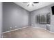 This carpeted bedroom includes a ceiling fan and a window that lets in natural light at 1017 E Maryland Ave # 110, Phoenix, AZ 85014