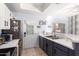 This open kitchen has a stainless refrigerator and access to the backyard at 1017 E Maryland Ave # 110, Phoenix, AZ 85014
