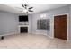 Inviting living room featuring a fireplace, neutral tile flooring, and bright natural light at 1017 E Maryland Ave # 110, Phoenix, AZ 85014