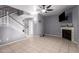 Open living area with neutral tones, a cozy fireplace, and easy access to the staircase at 1017 E Maryland Ave # 110, Phoenix, AZ 85014