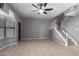 Spacious living room offering neutral decor, tiled floors, and a staircase leading to upper level at 1017 E Maryland Ave # 110, Phoenix, AZ 85014