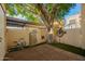 Private patio area with artificial turf, mature tree, and bike rack at 1017 E Maryland Ave # 110, Phoenix, AZ 85014
