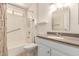 This bathroom offers a shower-tub combo and a vanity with granite countertop at 10329 W Floriade Dr, Sun City, AZ 85351