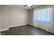 This bedroom features a ceiling fan, gray walls, and wood-look floors at 10562 W Campana Dr, Sun City, AZ 85351