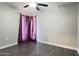 This bedroom features a ceiling fan, gray walls, and wood-look floors at 10562 W Campana Dr, Sun City, AZ 85351