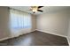 This bedroom features a ceiling fan, gray walls, and wood-look floors at 10562 W Campana Dr, Sun City, AZ 85351