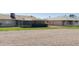 Backyard view of a home with a screened-in porch and rock landscaping and a grass perimeter at 10562 W Campana Dr, Sun City, AZ 85351