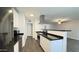 Modern kitchen featuring stainless steel appliances, white cabinets and a breakfast bar at 10562 W Campana Dr, Sun City, AZ 85351