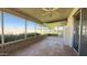 Enclosed patio with tile flooring, providing a relaxing outdoor space with views of the backyard and landscaping at 10562 W Campana Dr, Sun City, AZ 85351