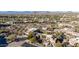 Expansive aerial view of a desert home in a golf community with mountain views and arid landscaping at 10638 E Hedgehog Pl, Scottsdale, AZ 85262