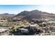 Bird's eye view of a luxury home set in a desert hillside community with mountain backdrop at 10638 E Hedgehog Pl, Scottsdale, AZ 85262