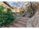 Secluded backyard oasis featuring a stone fire pit, comfortable seating, and lush landscaping, perfect for outdoor enjoyment at 10638 E Hedgehog Pl, Scottsdale, AZ 85262